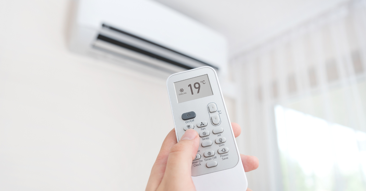 Person using remote for air conditioner