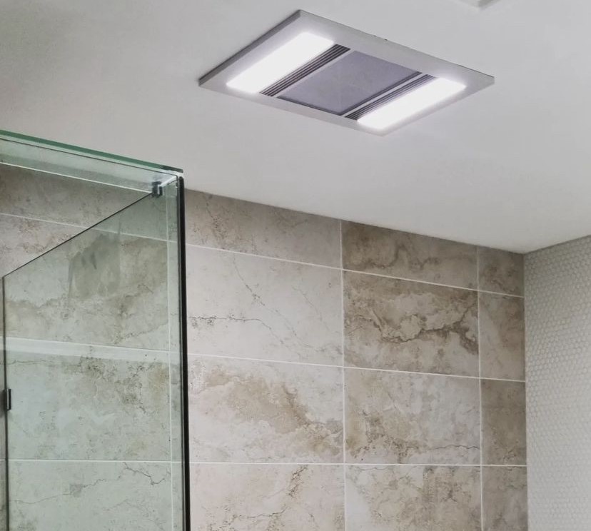 A quiet bathroom light with fan switched on, located on the ceiling in a modern bathroom.